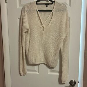 White sweater with crossing front. Low cut.